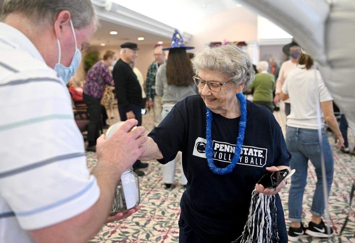 Shirley Derr donates to Penn State’s Thon after participating in 46 minutes of dancing for the Juniper Village’s mini-Thon on Monday.