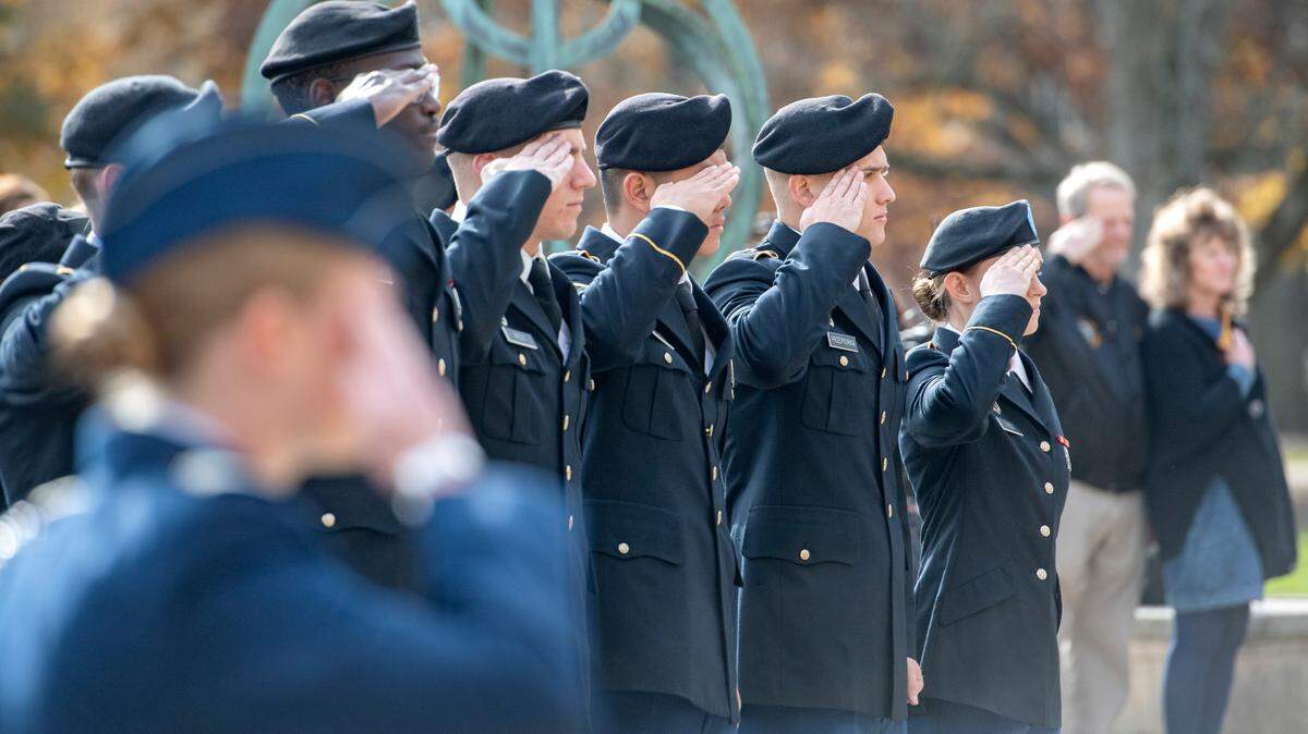 Penn State ROTC members salute as the national anthem plays at the annual Penn State Veterans Day ceremony on Nov. 11, 2021 in front of Old Main.