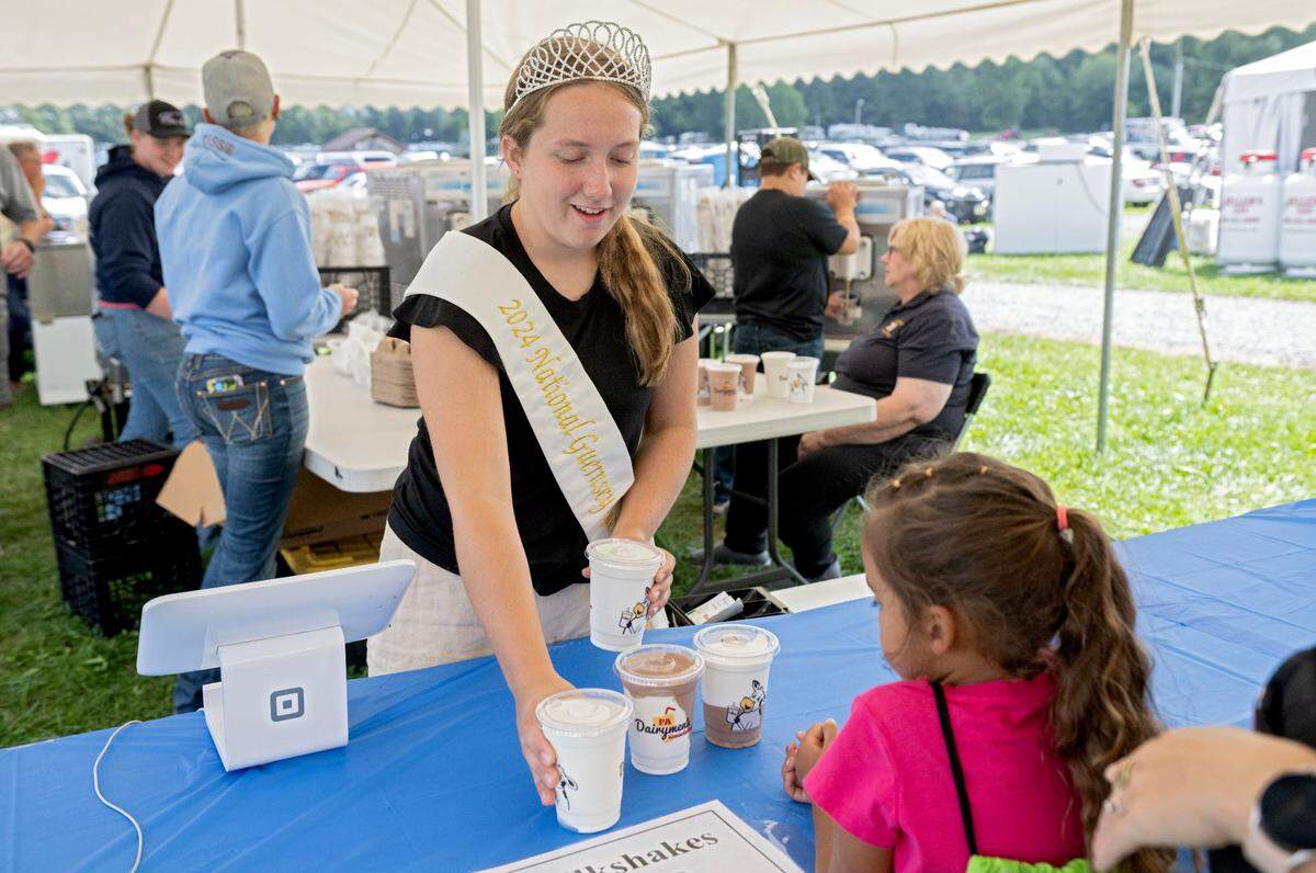 Breann Poole, the 2024 National Guernsey Queen, helps to serve milkshakes at the Penn State Ag Progress Days on Tuesday, August. 13, 2024.