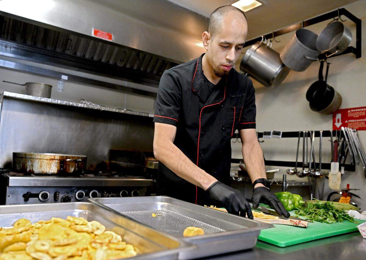 George Salgado makes tostones for a Puerto Rican themed meal at Tau Kappa Epsilon on Tuesday, Jan. 16, 2024.