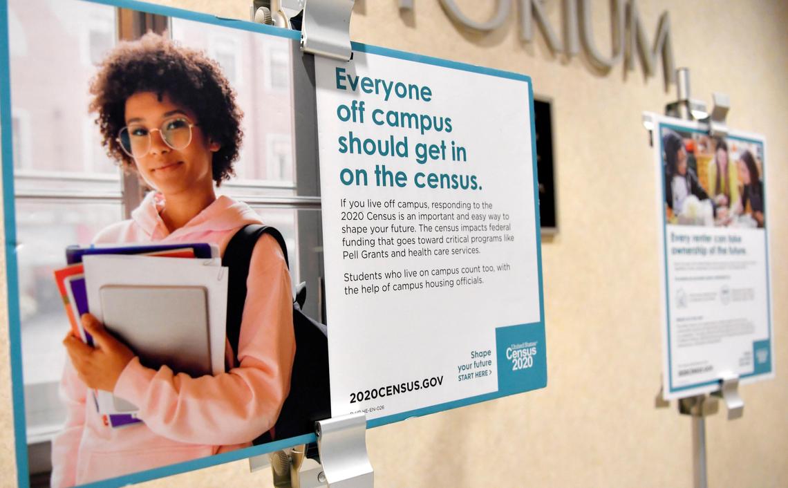 Signs promoting participation in the 2020 census hang during a panel discussion on Wednesday in the HUB at Penn State.