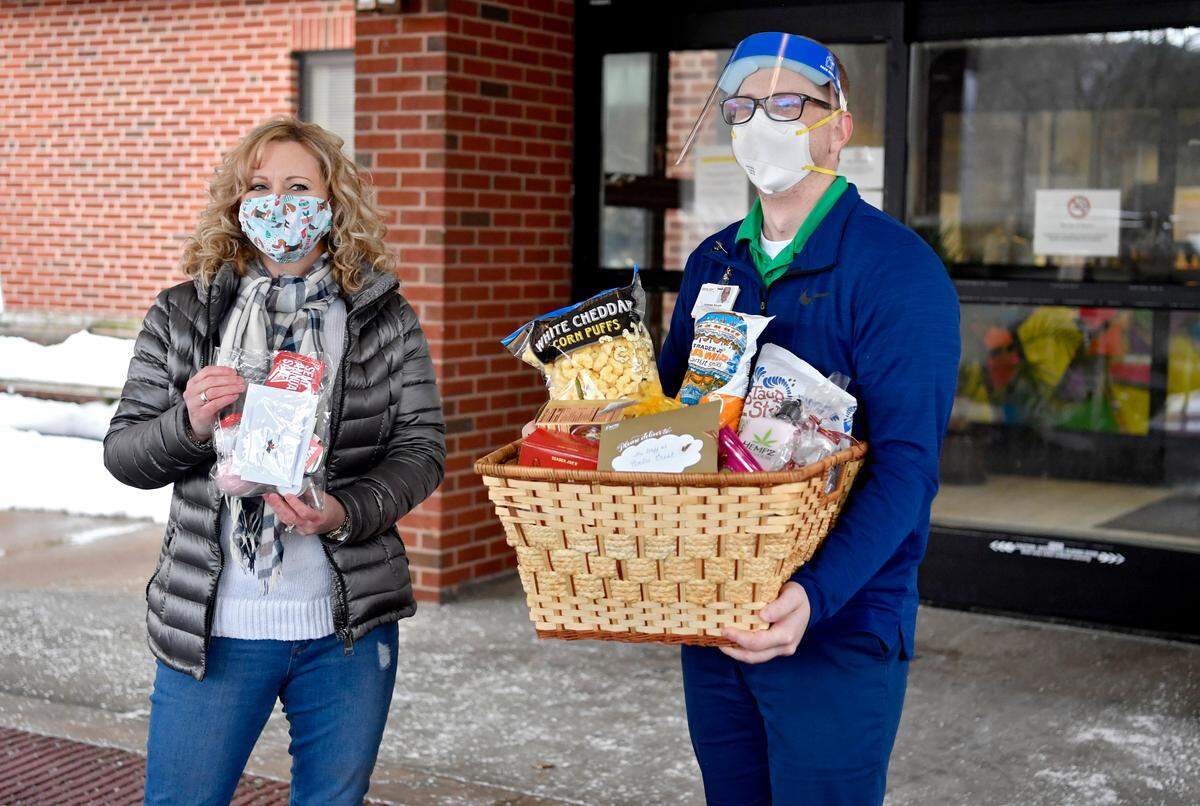 Maureen Casey delivers 265 goodie bags for the employees of Centre Crest to administrator Andrew Naugle on Tuesday, Dec. 22, 2020.