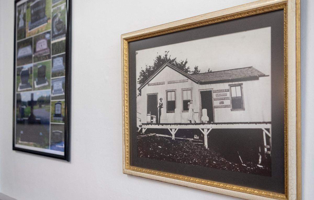 An old photo of the original shop hangs in Mayes Memorials in Lemont on Thursday, Feb. 16, 2023.