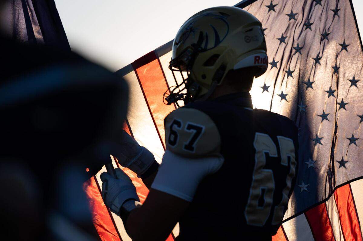 Gage Watson holds a flag before Bald Eagle Area High School’s game against Martinsburg Central High School on Friday, Sept. 11, 2020 in Wingate, PA.