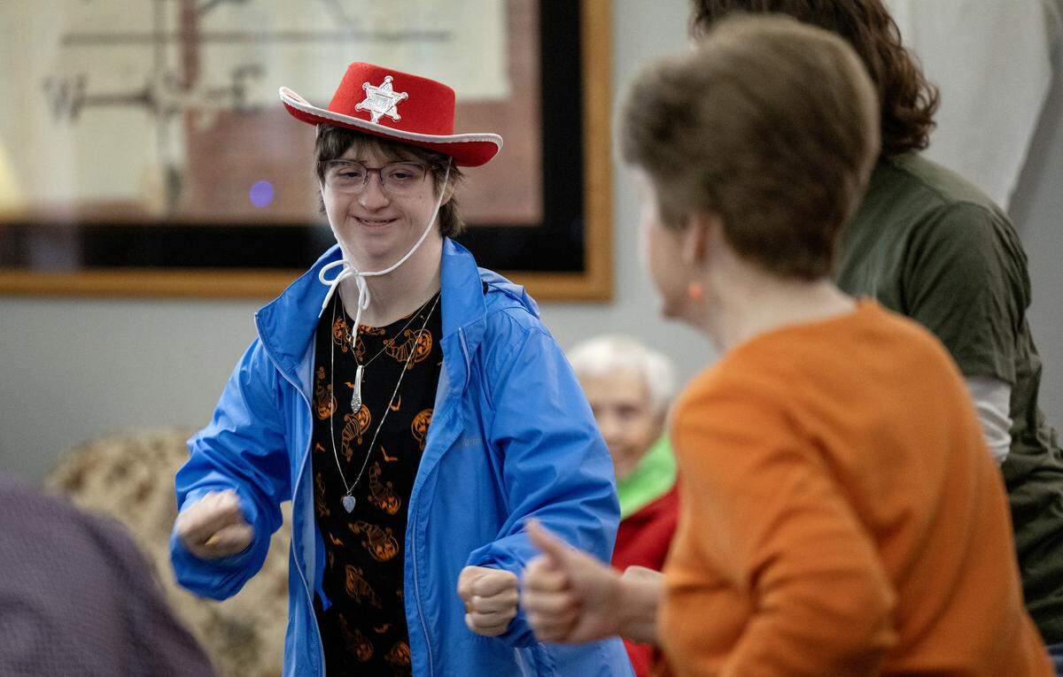 Ashley Harter, a volunteer through CARES Central PA, dances during square dancing at the Wynwood House in Centre Hall on Thursday, Oct. 30, 2025. 