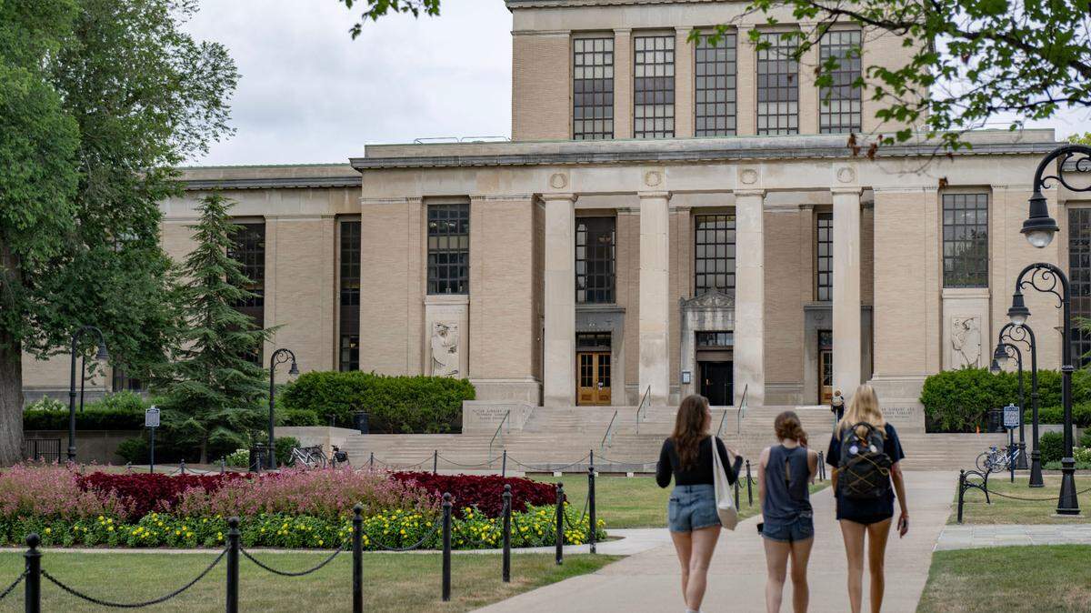 Students walk on the Penn State campus by the Pattee Paterno Library on Thursday, July 18, 2024.