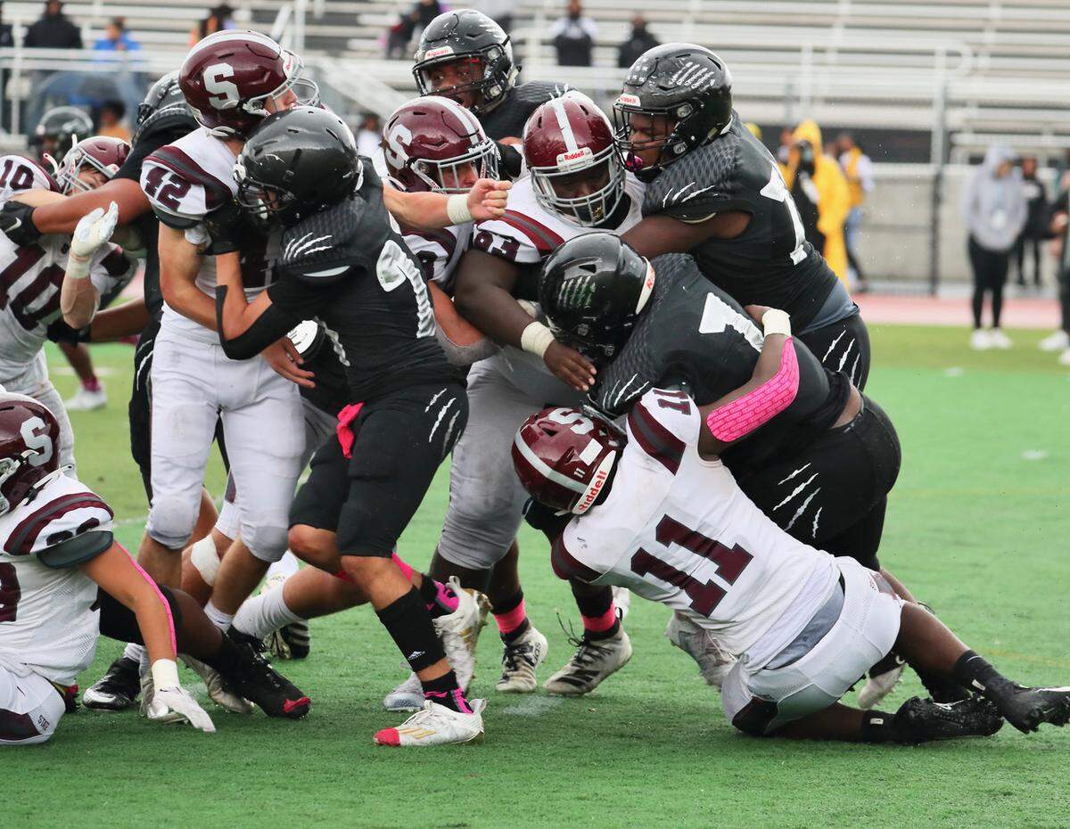 State College’s JW Scott (11) pulls down a Harrisburg player on Saturday, Oct. 23, 2021.
