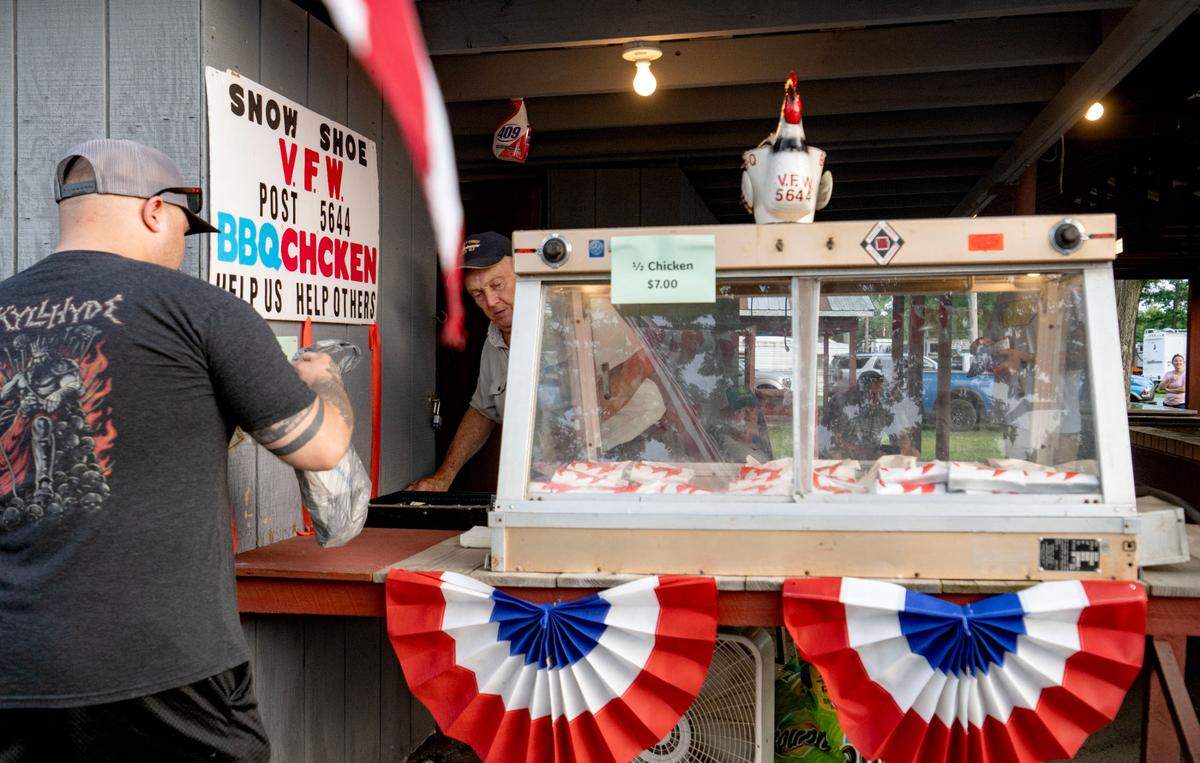 Members of the Snow Shoe VFW Post 5644 serve up half chickens at the Snow Shoe Carnival on Tuesday, June 18, 2024.
