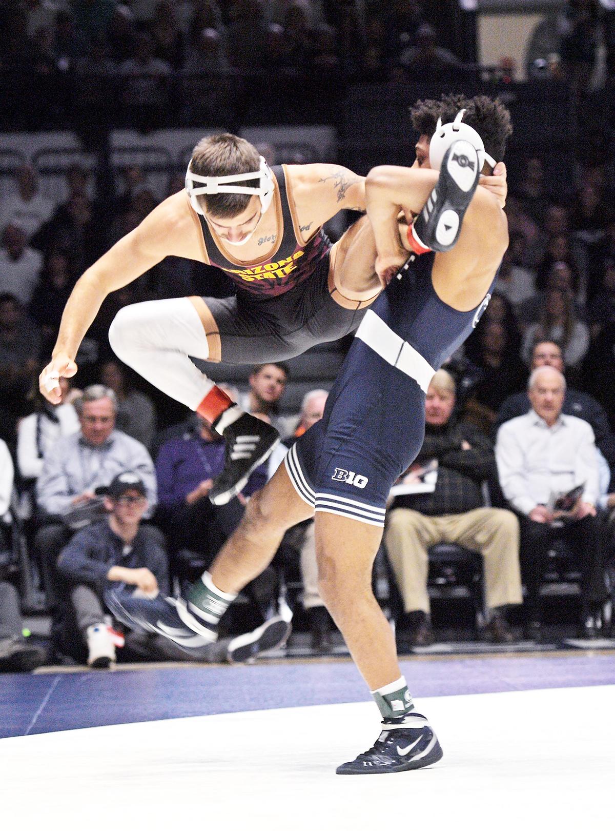 Penn State’s Roman Bravo-Young, 133 lbs, (right) lifts Arizona State’s Ryan Millhof off the matt for a take-down Friday at Rec Hall in State College. Bravo-Young won, 14-1. Penn State defeated Arizona State, 41-3. (For the CDT/Steve Manuel)