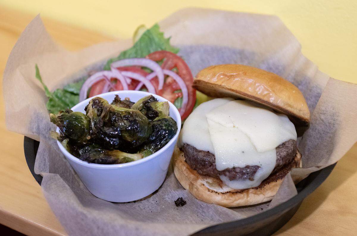 The Parlor burger and a side of roasted brussel sprouts at The Parlor in Bellefonte on Thursday, Aug. 14, 2025.