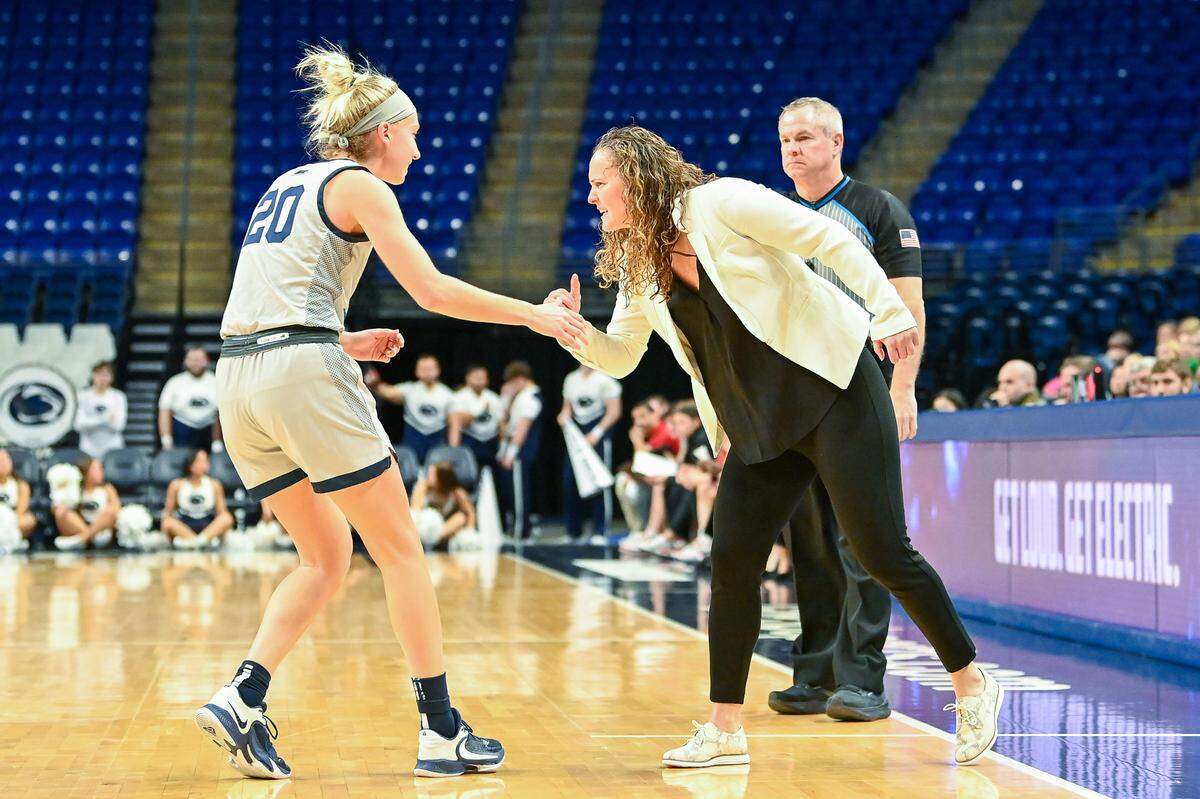 Penn State Head Coach Carolyn Kieger congratulates Makenna Marisa Sunday during the game against Nebraska.