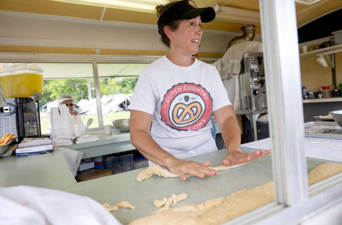 Carmalena Stoltzfus Iyengar rolls soft pretzels at the Dutch Country Concessions stand at the Centre County Grange Fair on Friday, Aug. 16, 2024.