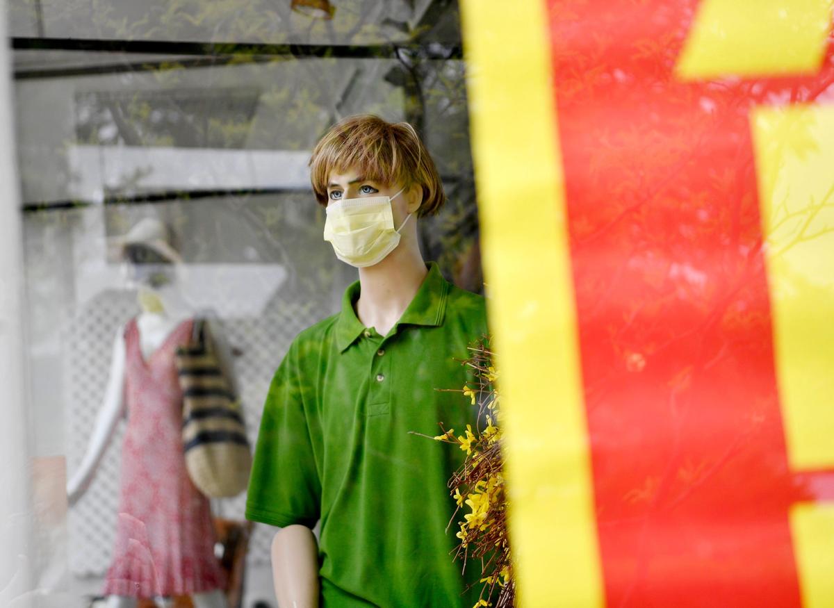A mannequin in the window of the FaithCentre wears a mask on Monday, May 18, 2020. The thrift store has reopened with health and safety precautions in place.