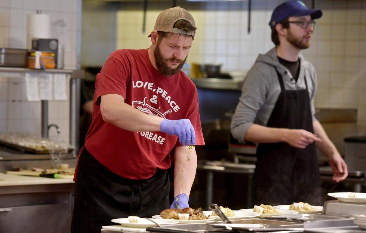 Herwig's Austrian Bistro owner Bernd Brandstatter puts the finishing seasonings on a meal Saturday.  Since announcing the restaurant's closure, Brandstatter said he and his staff are busier than they’ve been in years.