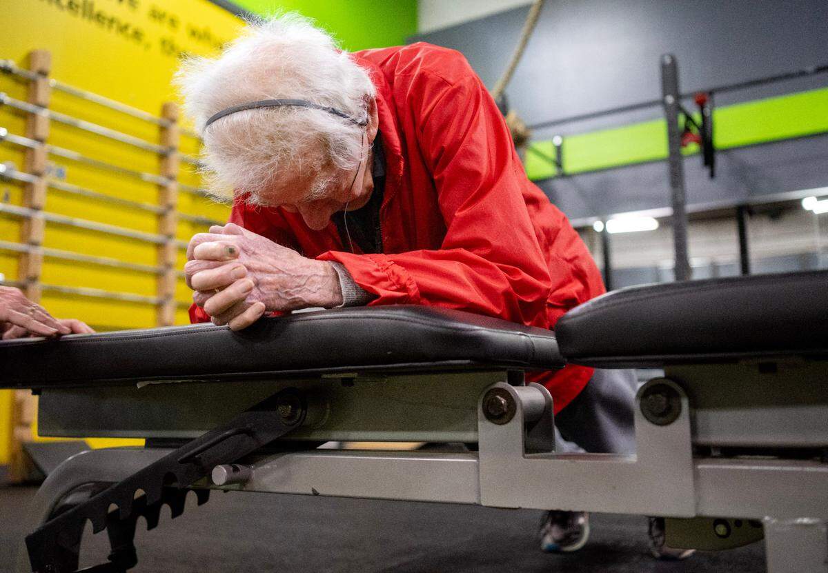 George Etzweiler holds an elevated plank for over a minute during his workout at Ki’netik Fitness on Friday, April 5, 2024.