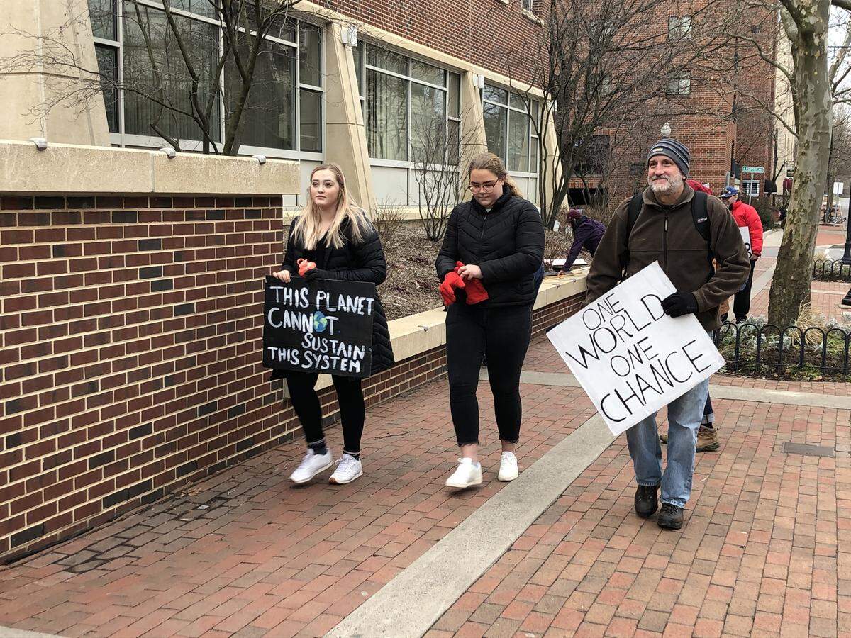 Centre County residents participate in a climate strike in downtown State College on Friday.