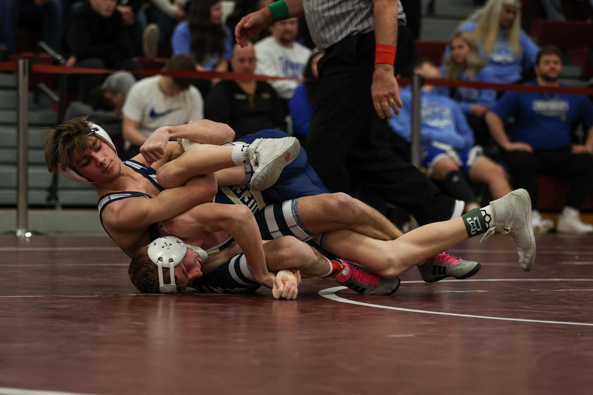 Philipsburg-Osceola’s Caleb Hummel looks for nearfall points on McGuffey’s Clayton Ealy in their 114 pound fifth-place match of the PIAA Class 2A Southwest Regional on Saturday in Altoona. Ealy topped Hummel, 5-4, in sudden victory.