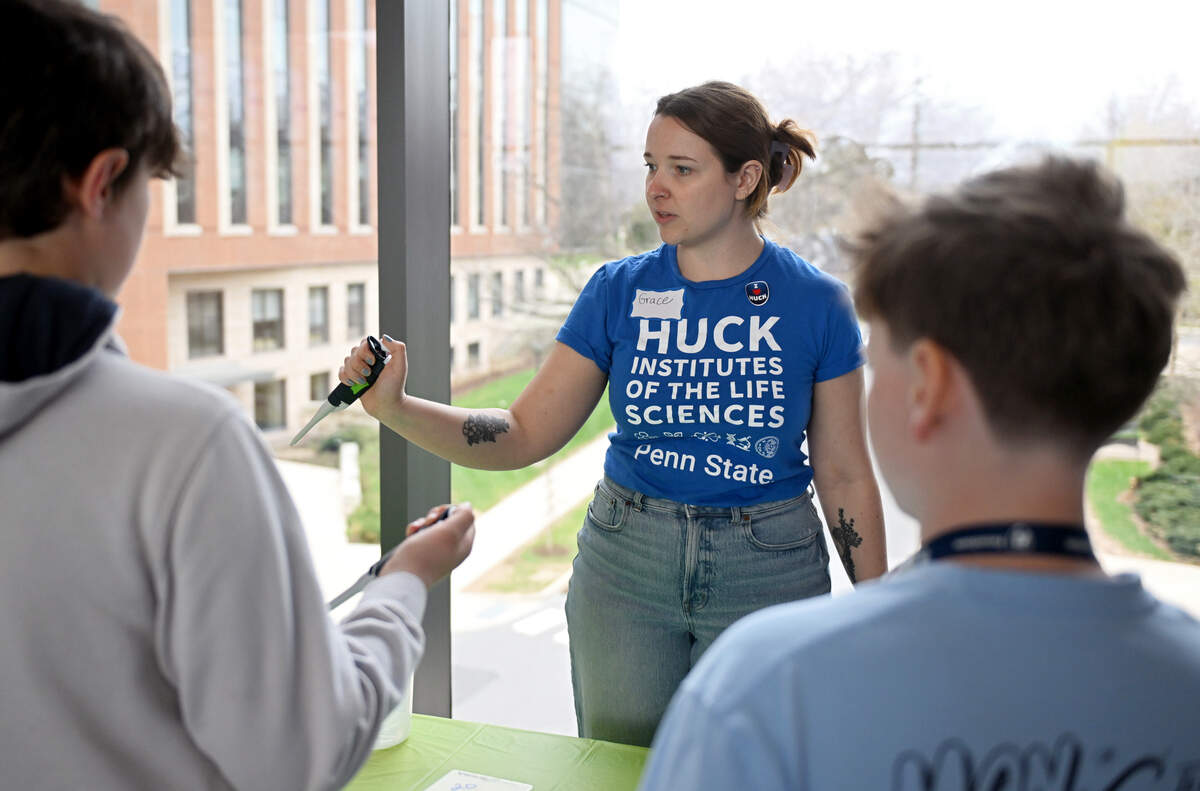 Grace Deitzler, research project manager for the One Health Microbiome Center, shows a group how to use pipettes during Penn State’s Bring Our Children to Work Day on Monday, April 13, 2026.