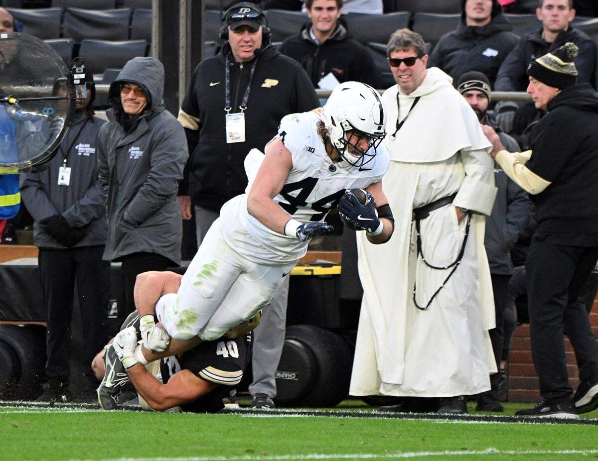Nov 16, 2024; West Lafayette, Indiana, USA; Penn State Nittany Lions tight end Tyler Warren (44) is tackled by Purdue Boilermakers linebacker Hudson Miller (40) during the second quarter at Ross-Ade Stadium. Mandatory Credit: Marc Lebryk-Imagn Images