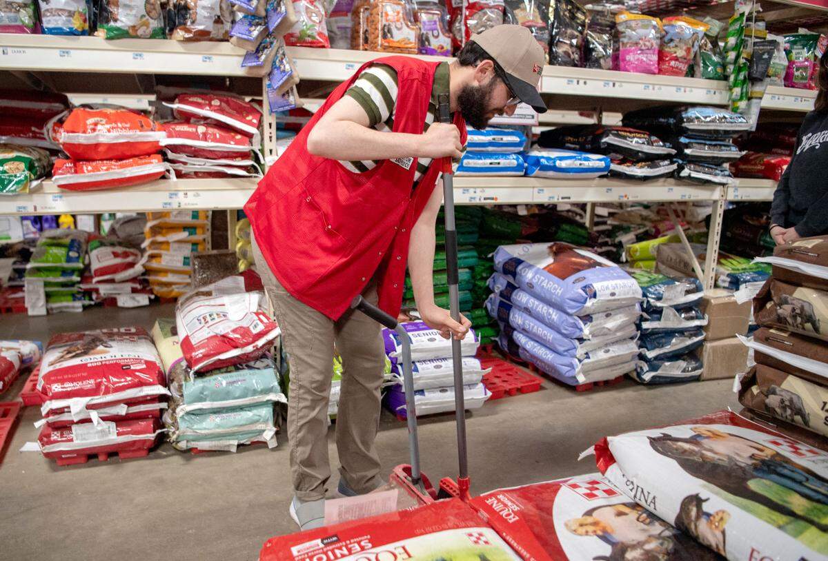 Caleb Ryland sweeps at Tractor Supply Co. through his internship on Thursday, April 7, 2022.
