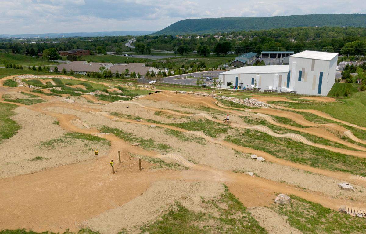 Mack Marshall, 7, bikes at the Harvest Fields community trails new skills park on Monday, May 22, 2023.