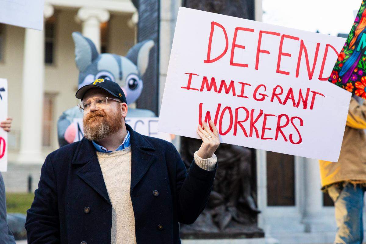 Bellefonte Borough Council member Zach Kelly holds a sign that reads “defend immigrant workers” during an anti-ICE protest in front of the Centre Country Courthouse in Bellefonte Wednesday, March 18, 2026. 
