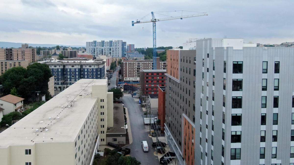 An aerial look at some of the high-rises and construction for a new building on the east end of downtown State College in July 2022.