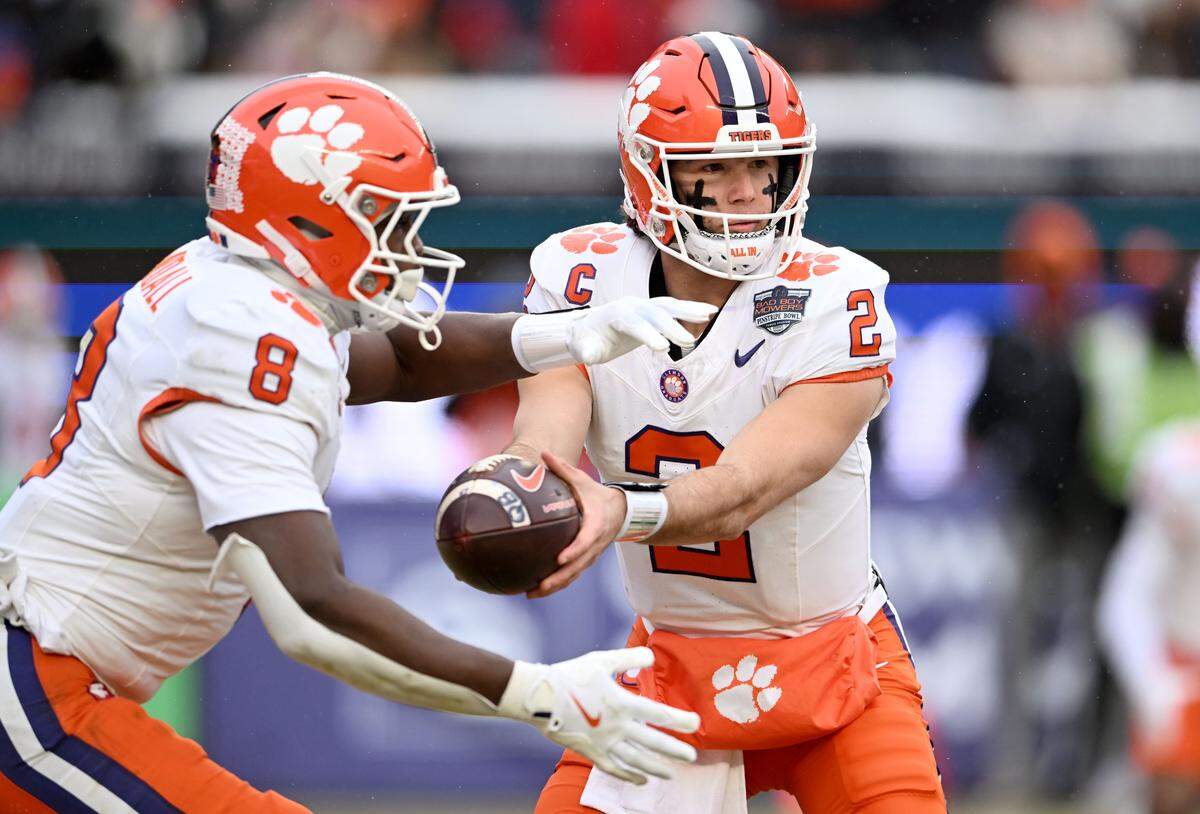 Clemson quarterback Cade Klubnik hands off to Adam Randall during the Pinstripe Bowl against Penn State at Yankee Stadium on Saturday, Dec. 27, 2025.
