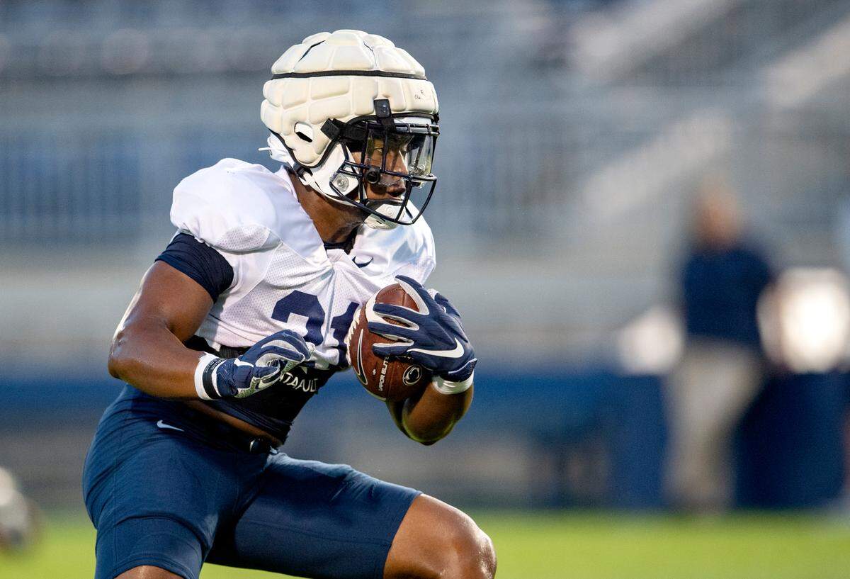 Penn State running back Noah Cain runs a drill during practice on Wednesday, Aug. 25, 2021 in Beaver Stadium.
