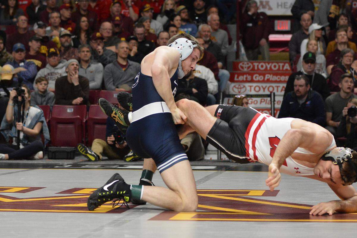 Penn State’s Nick Lee works to keep Wisconsin’s Tristan Moran from escaping in their 141-pound consolation semifinals bout of the Big Ten Championships on Sunday in Minneapolis, Minn. Lee earned an 11-2 major decision over Moran to advance to the third-place match.