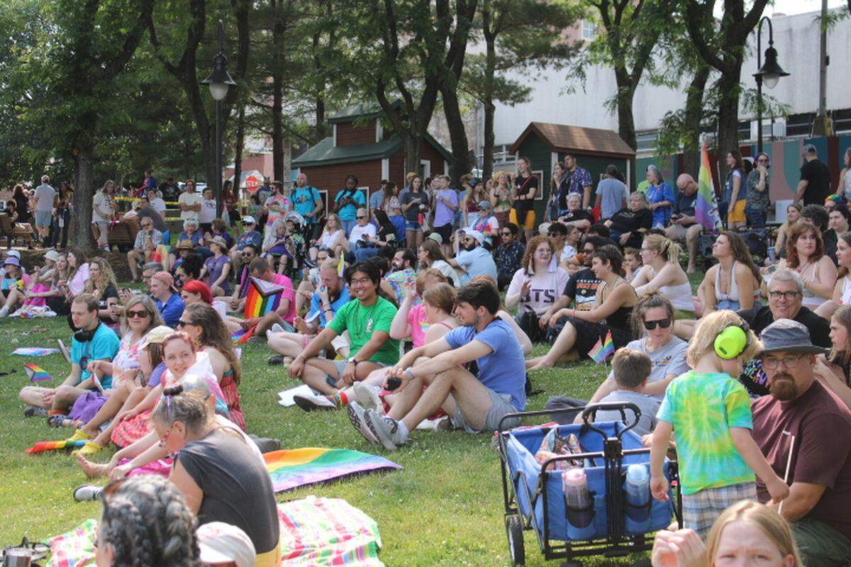 Festival-goers sit in the grass at Sidney Friedman Park as they wait for the Pride Festival to begin on Saturday, June 10, 2023.
