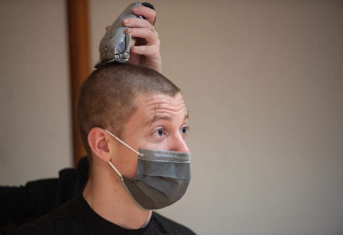 Trevor Schoenemann gets a buzz cut Tuesday during the Penn State Thon “No Hair, Don’t Care” event.