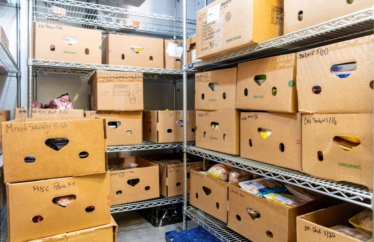 Boxes are stacked in the freezer at the State College Food Bank on Thursday, May 26, 2022.