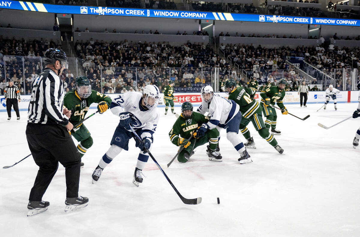 Penn State's Gavin McKenna skates around Clarkson defenders during the game on Thursday, Oct. 9, 2025.  Clarkson won, 6-4.