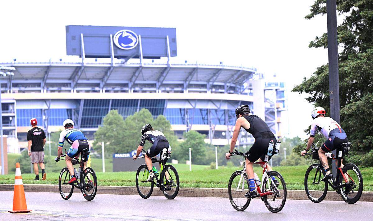 Participants in the Ironman 70.3 Pennsylvania Happy Valley bike toward Beaver Stadium on Sunday, July 2, 2023.