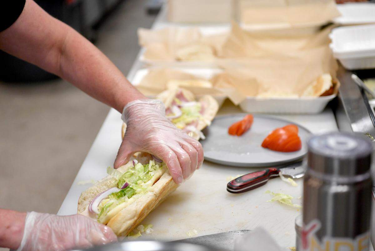 The kitchen staff at Blonde Bistro prepares sandwiches during the lunch rush on Friday.