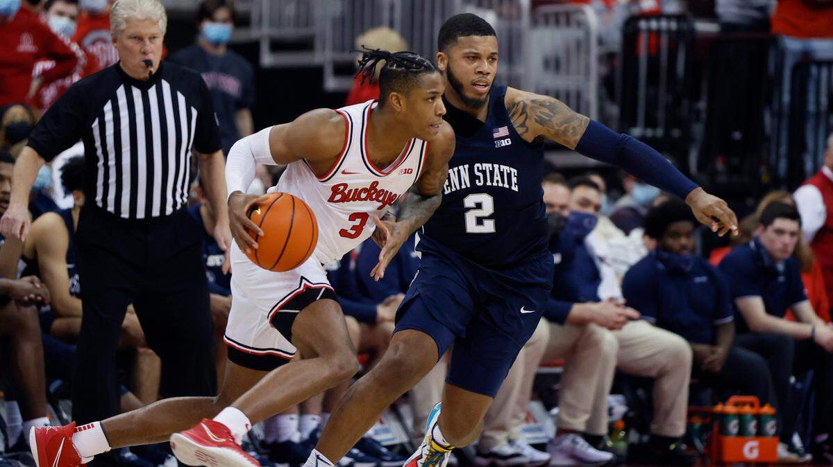 Ohio State’s Eugene Brown, left, looks for an open pass as Penn State’s Myles Dread defends during the first half of an NCAA college basketball game Sunday.