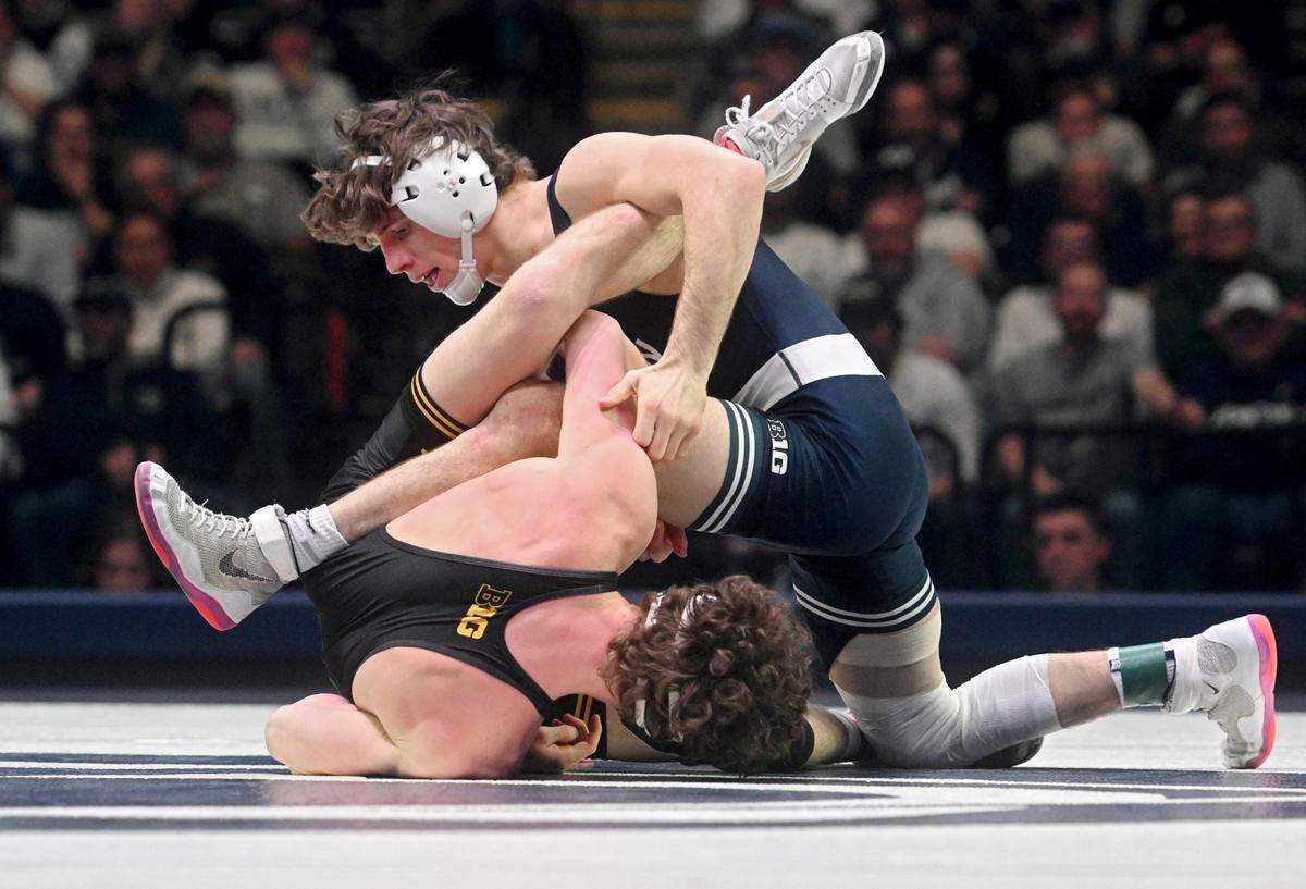 Penn State’s Levi Haines wrestles Iowa’s Cobe Siebrecht in the 157 lb bout of the match on Friday, Jan. 27, 2023.