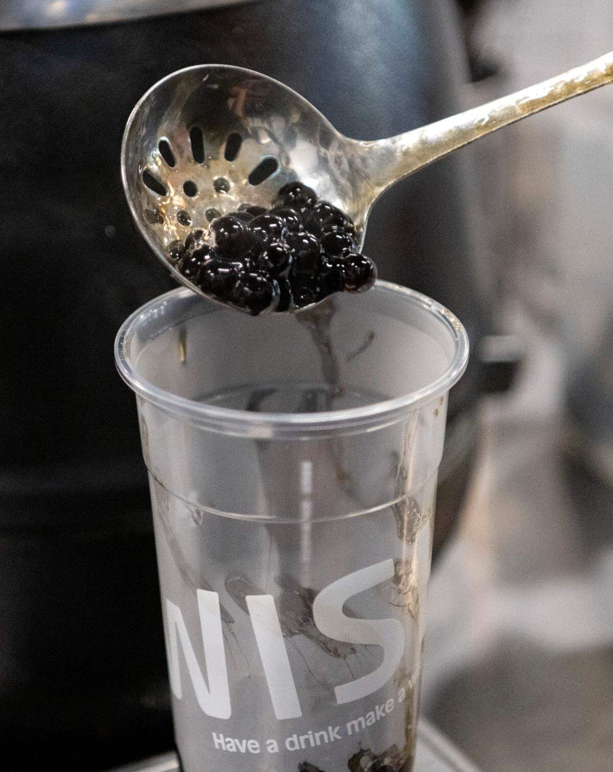Pearls are measured into a a Black Tiger Milk tea at Mr. Wish in downtown State College on Monday, Nov. 21, 2022.