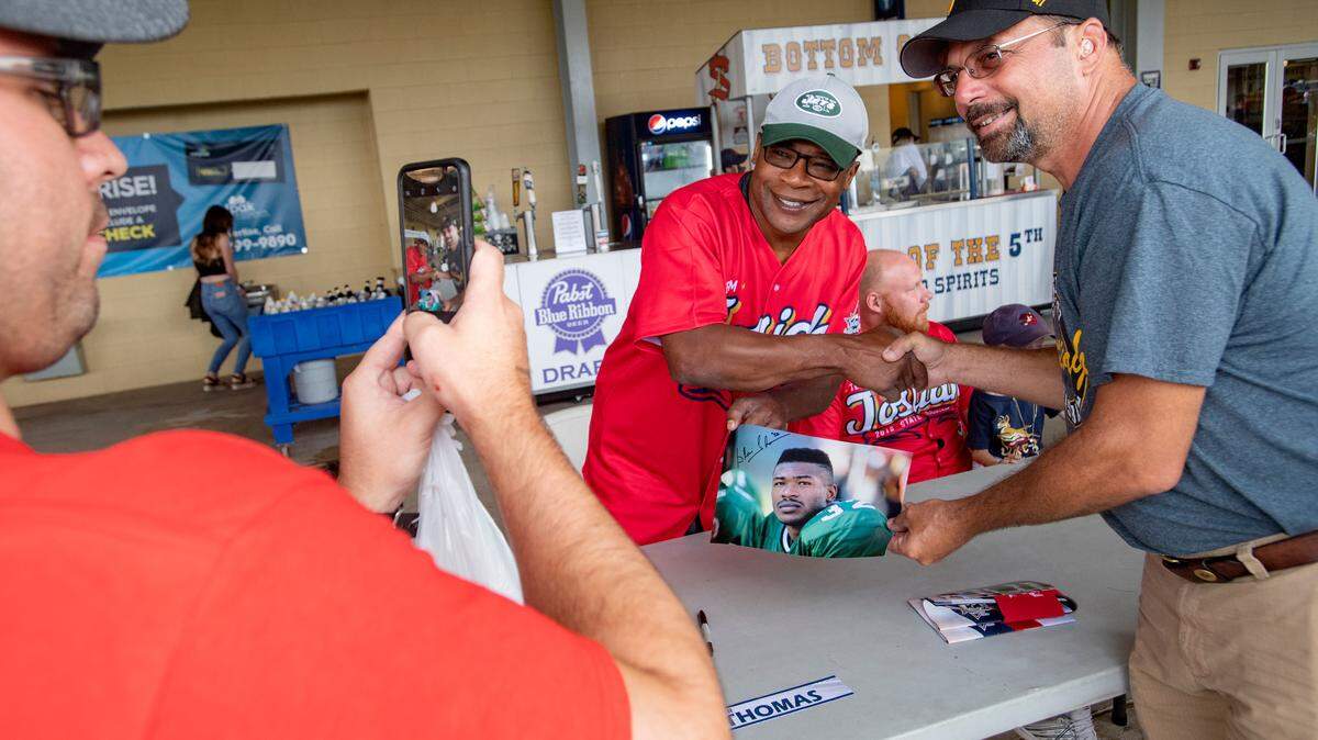 Former Penn State football star and NFL player Blair Thomas signs autographs for fans at Medlar Field on Tuesday, August 14, 2018.  Thomas was to play in the celebrity softball game at the New York Penn League All Star game, but it was canceled due to the rain.  