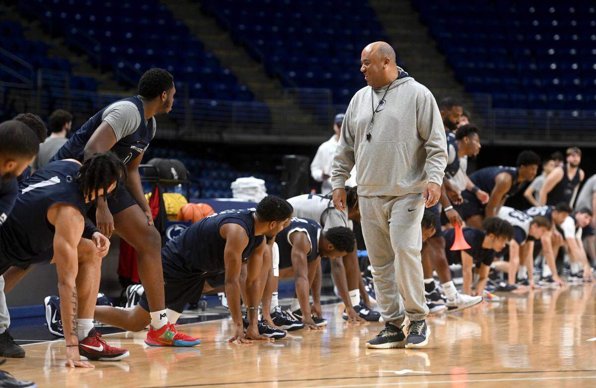 Penn State men’s basketball coach Micah Shrewsberry jokes with players as they stretch for practice on Tuesday, Oct. 25, 2022.