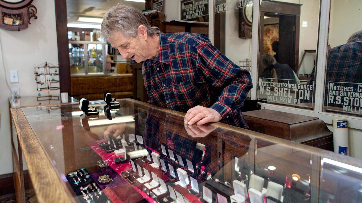 Richard Winebold places rings in the display case at Penns Valley Jewelers on Thursday, Dec. 16, 2021.