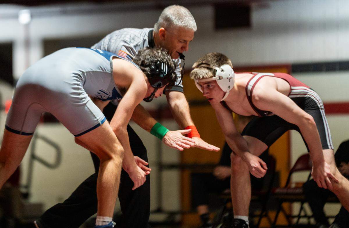 Chambersburg and State High wrestlers face off before the start of a match during a dual at State College Area High School on Friday, Jan. 23, 2026, in State College, Pa. The Little Lions defeated the Trojans 45-22.