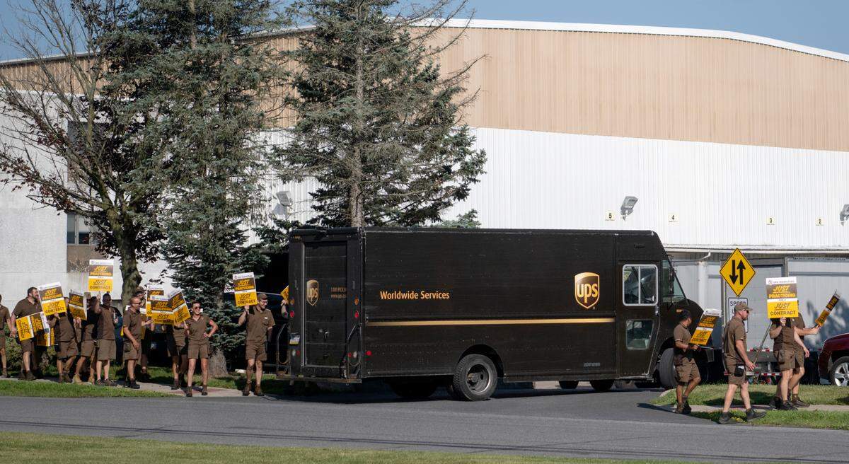 A UPS delivery truck enters the parking lot of the State college UPS Customer Center as local UPS workers from the 764 Teamsters union practiced picketing on Thursday, July 13, 2023.