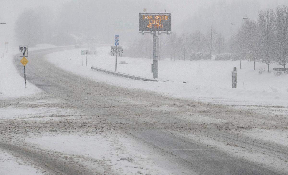 The intersection of North Atherton Street Valley Vista Drive is covered in snow the digital a sign warns of a lowered speed limit on I-99 on Thursday, Dec. 22, 2022.