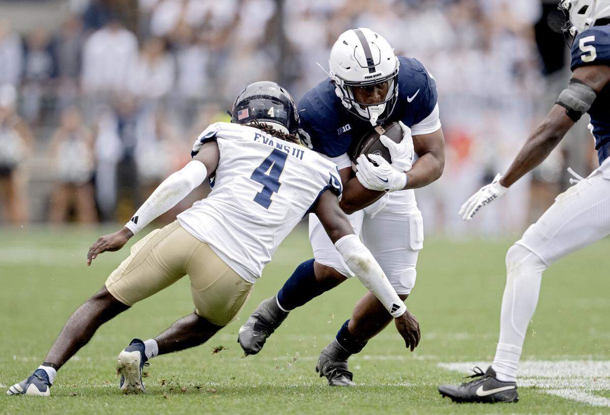 Penn State running back Kaytron Allen cuts down the field with the ball from FIU defender Victor Evans III during the game on Saturday, Sept. 6, 2025 at Beaver Stadium.