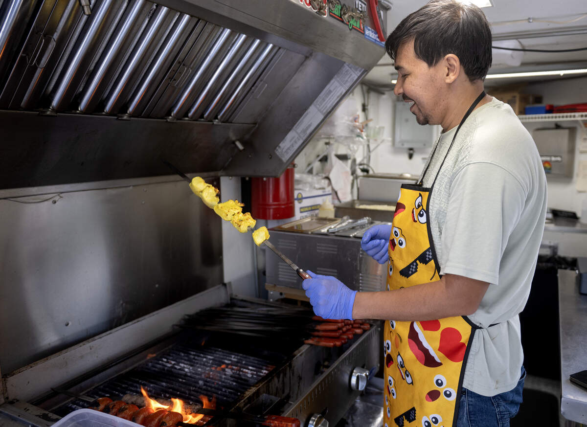 Mohammad Hashami of Fatema’s Kitchen checks a chicken kebab as it grills on Tuesday, June 2, 2026 at the Boalsburg Farmers Market. The chicken for the kebabs is marinated for several days.