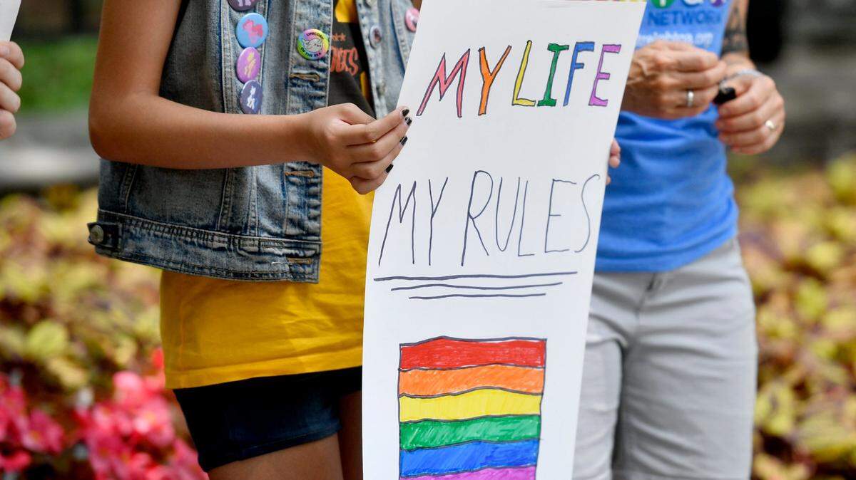High school students gather together to show their support of the LGBTQ community at a Pride Rally at the Allen Street gates on Friday, June 30, 2017.