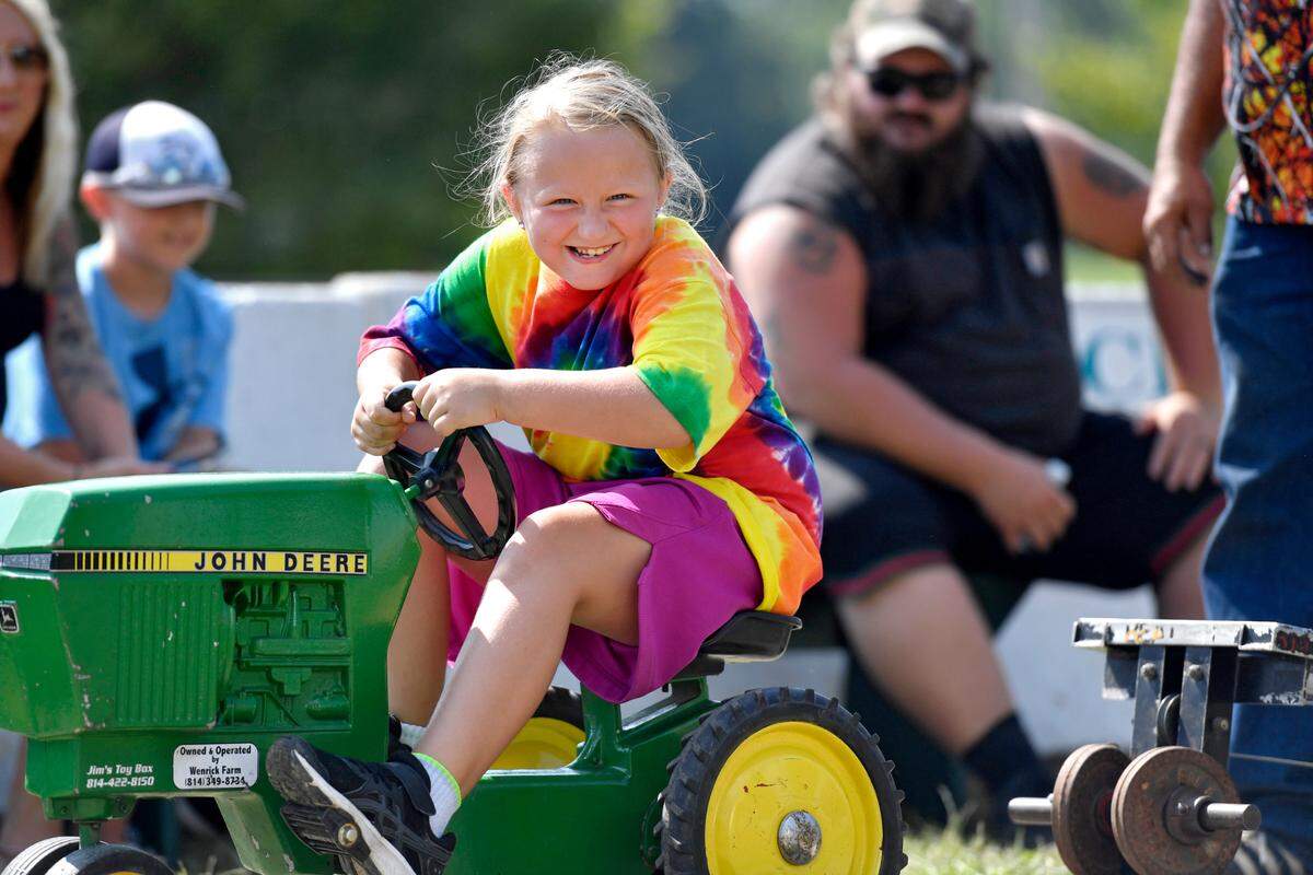 Seven year olds pull 135 pounds in the pedal tractor pull at the Centre County Grange Fair on Tuesday.