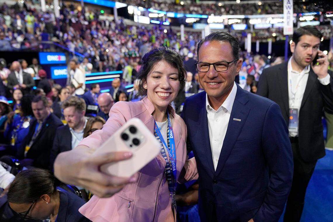 Pennsylvania Gov. Josh Shapiro poses for a selfie with an attendee on the floor during the first day of the Democratic National Convention at the United Center. The DNC program will feature President Joe Biden and Former Secretary of State Hillary Clinton during Monday's ceremonies.